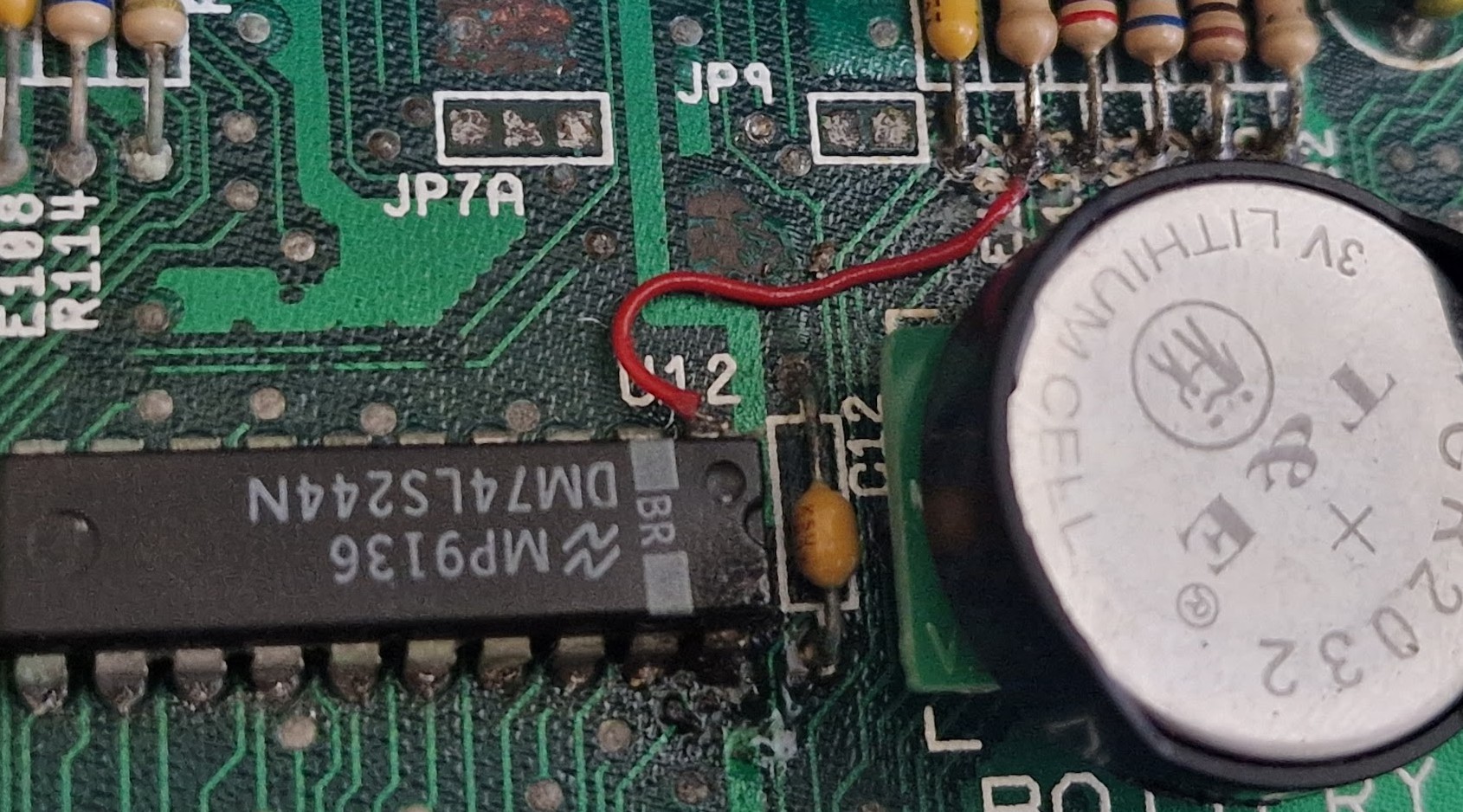 The jumper wire repair that brought the board back to life enough for DiagROM to start producing serial output.